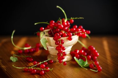 ahşap bir masa üzerinde olgun meyveleri kırmızı kuş üzümü