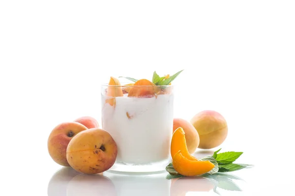 Homemade yogurt with ripe apricots on a white — Stock Photo, Image