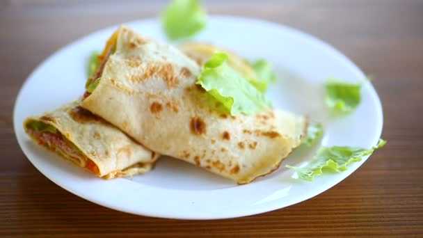 Tortitas finas con hojas de ensalada y tocino en un plato — Vídeos de Stock