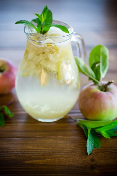 ガラスのデカンタでミントの小枝を新鮮なリンゴの夏の甘い冷たいコンポート — ストック写真
