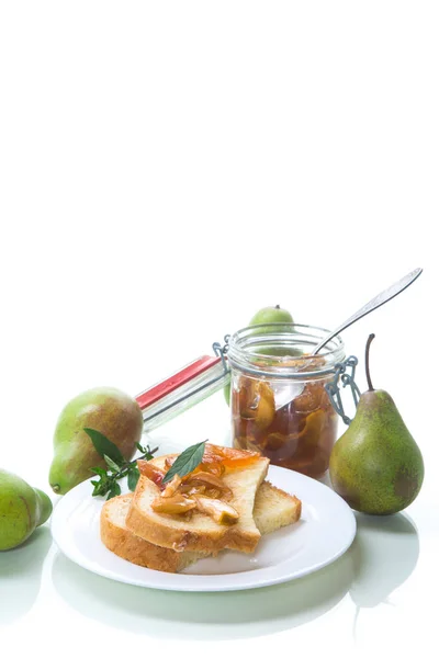 pieces of bread with sweet home-made fruit jam from pears and apples in a plate on a white background