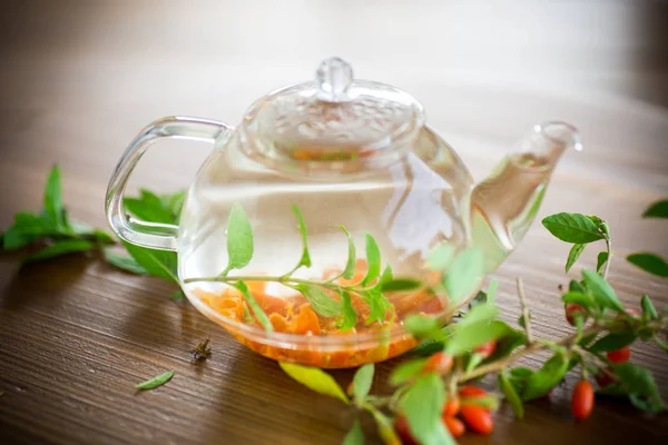 Hot Tea Ripe Red Goji Berries Glass Teapot Wooden Table — Stock Photo, Image