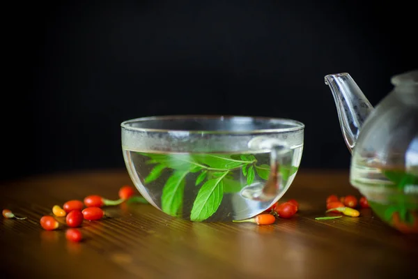 Hot Tea Ripe Red Goji Berries Glass Teapot Isolated Black — Stock Photo, Image