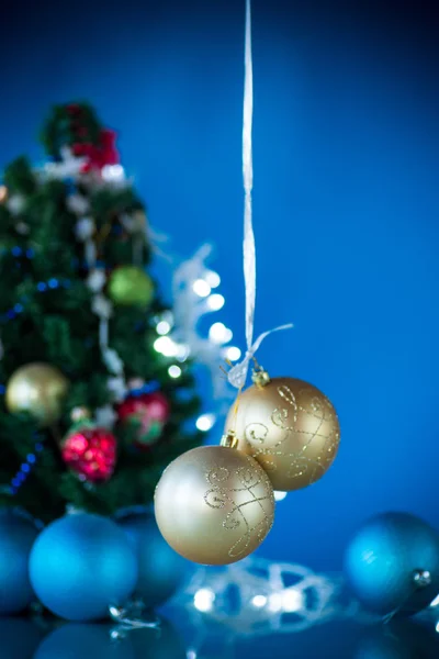 Christmas toys with a Christmas tree on a blue background — Stock Photo, Image