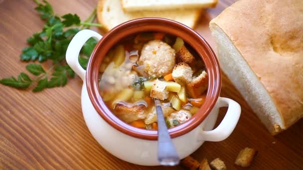 Vegetable soup with beans and meatballs in a ceramic bowl — Stock Video