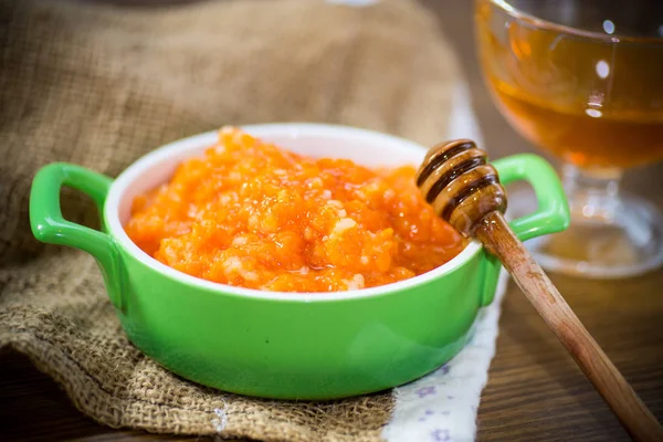 Boiled sweet pumpkin porridge with rice in a plate