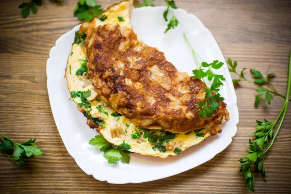 Fried omelet with cauliflower and greens in a plate — Stock Photo, Image