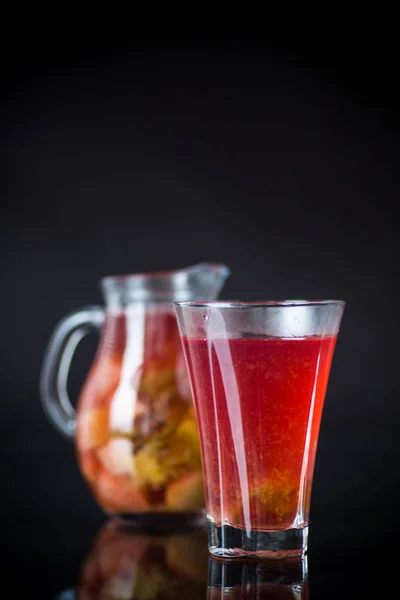 Червоний фруктовий компот в деканаторі зі склянкою Ліцензійні Стокові Фото