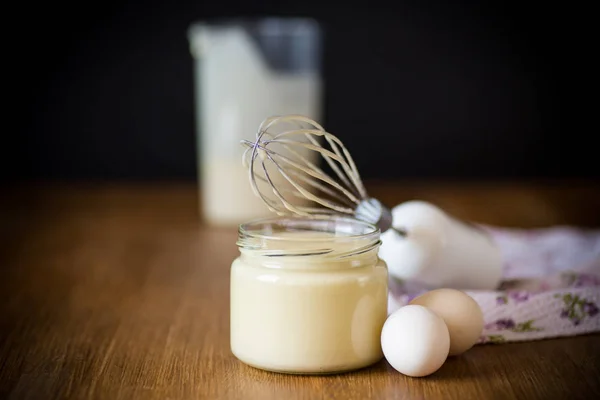 Homemade mayonnaise in a glass jar on a wooden — Stock Photo, Image