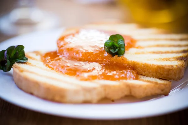 Fried toast with apricot jam in a plate — Stock Photo, Image