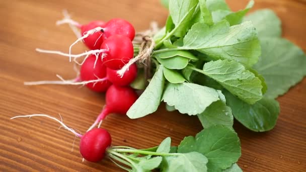 Fresh organic red radish on a wooden table — Stock Video