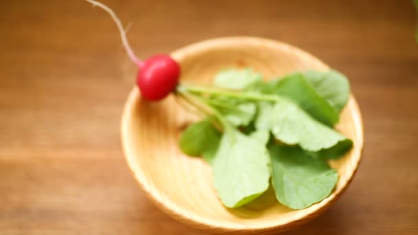 Fresh organic red radish on a wooden table — Stock Video