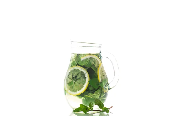 Fresh cold lemonade with lemons and mint in a carafe isolated on white — Stock Photo, Image