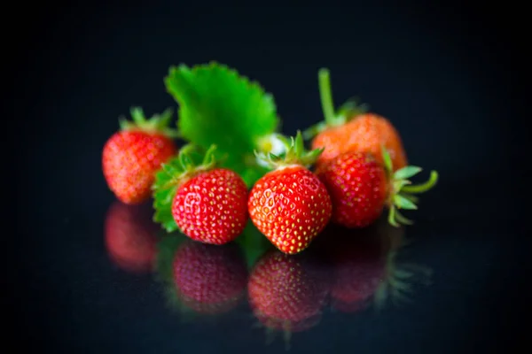 Ripe red strawberries on a black background — Stock Photo, Image