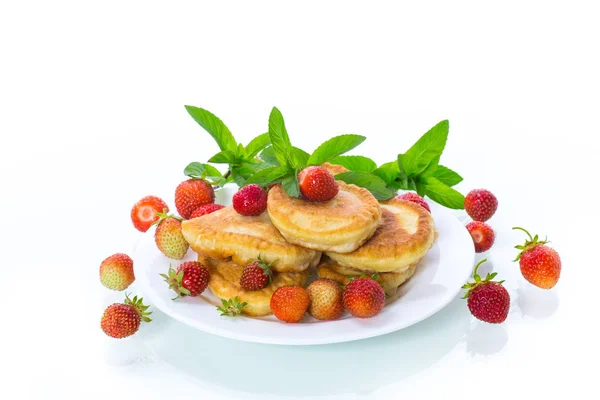 Tortitas dulces fritas con fresas maduras en un plato —  Fotos de Stock