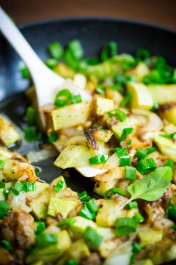 kabak ahşap bir masa üzerinde bir tavada soğan ve otlar ile kızartılmış