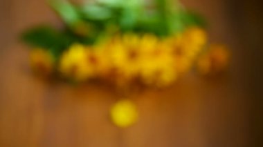 bir ahşap üzerinde sarı büyük papatyalar buketi