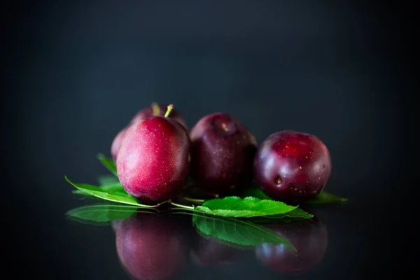 Organic red ripe cherry plum isolated on black — Stock Photo, Image