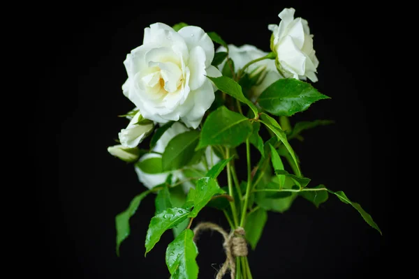 Bouquet of beautiful white roses on a black Stock Photo