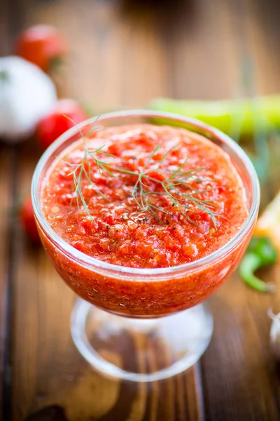 Homemade hot adjika from tomatoes, hot and sweet peppers with spices — Stock Photo, Image