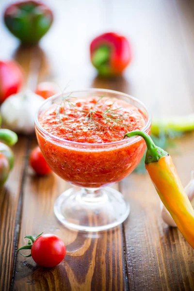 Homemade hot adjika from tomatoes, hot and sweet peppers with spices — Stock Photo, Image