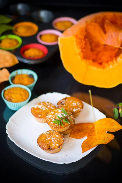 baked sweet pumpkin muffins with dried apricots inside