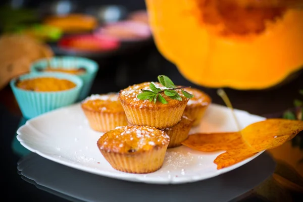 Baked sweet pumpkin muffins with dried apricots inside — Stock Photo, Image