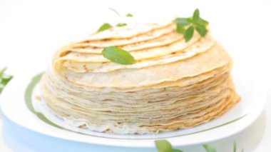 beyaz arka planda, bir tabakta çok kızarmış ince krep.