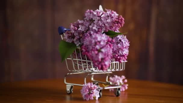 bouquet of spring blossoming lilacs in a shopping cart