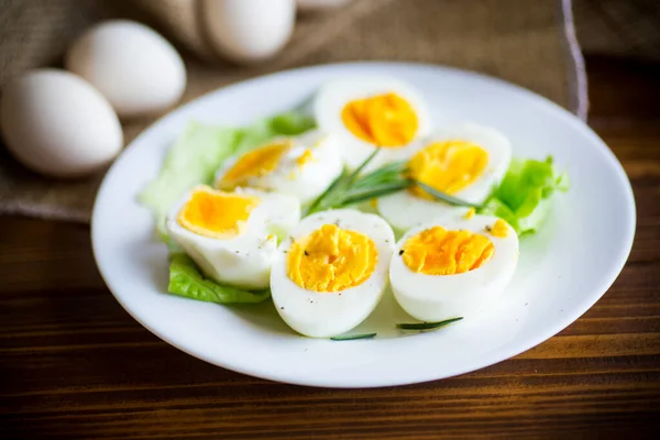 Boiled eggs with salad leaves in a plate — Stock Photo, Image