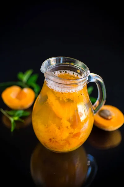 Cold apricot compote in a glass decanter — Stock Photo, Image