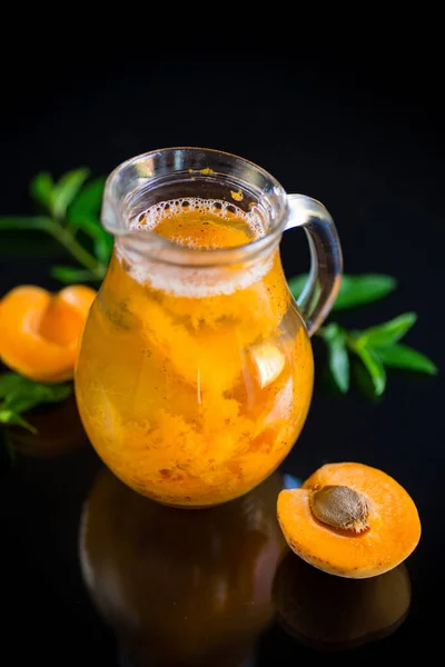 Cold apricot compote in a glass decanter — Stock Photo, Image