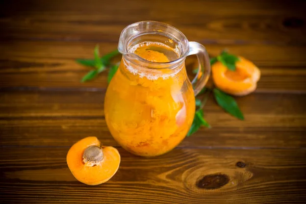 Cold apricot compote in a glass decanter — Stock Photo, Image