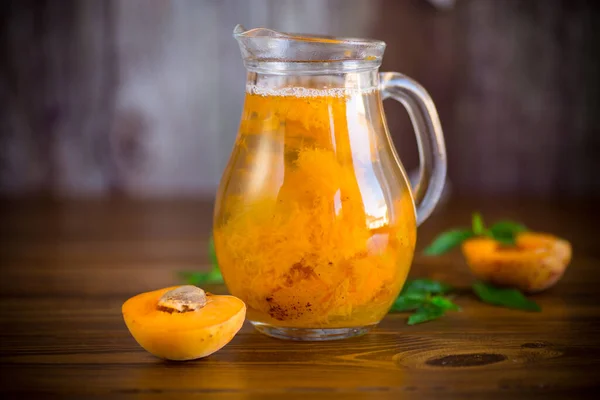 Cold apricot compote in a glass decanter — Stock Photo, Image