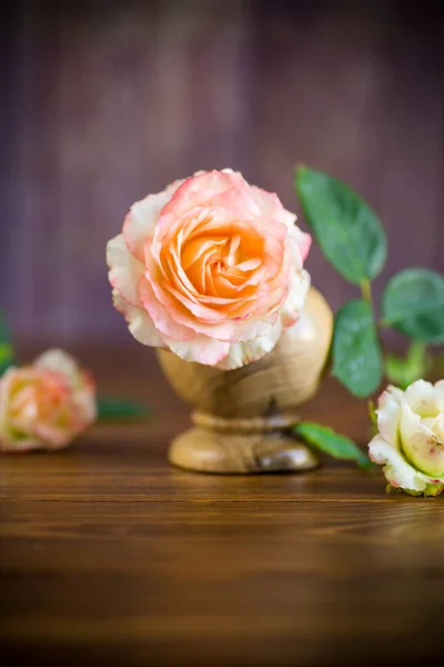 Небольшой букет красивых розовых роз на деревянном столе — стоковое фото