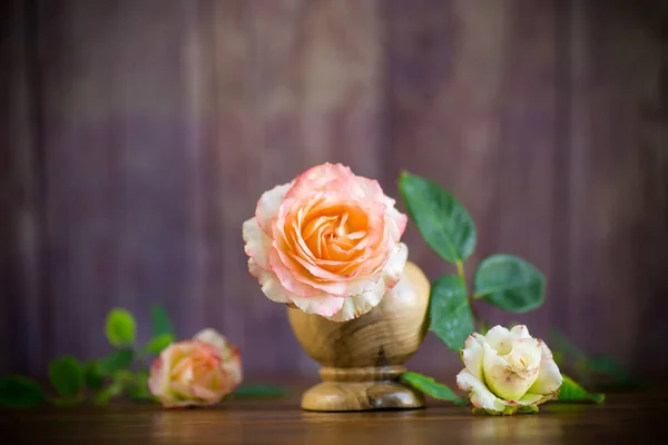 Liten bukett vackra rosa rosor på ett träbord — Stockfoto