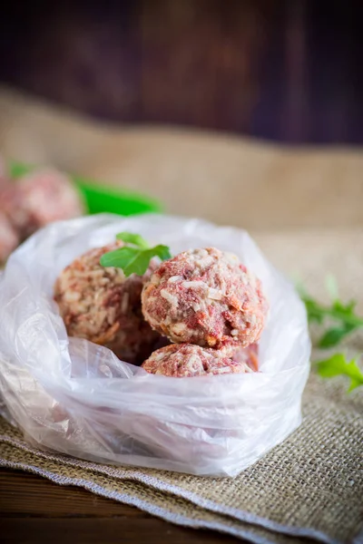 Frozen raw meatballs from beef and pork with carrots and rice — Stock Photo, Image