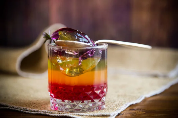 Sweet multi-colored fruit puff jelly in a glass cup — Stock Photo, Image