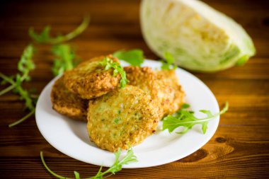 Sebzeli vejetaryen kızarmış lahana krepleri ahşap bir masada tabakta.