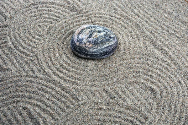 Zen composition. Garden of stones.Calming patterns on the sand.