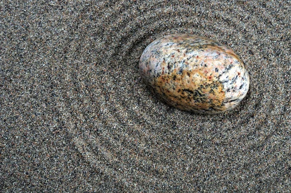 Zen composition. Garden of stones.Calming patterns on the sand.