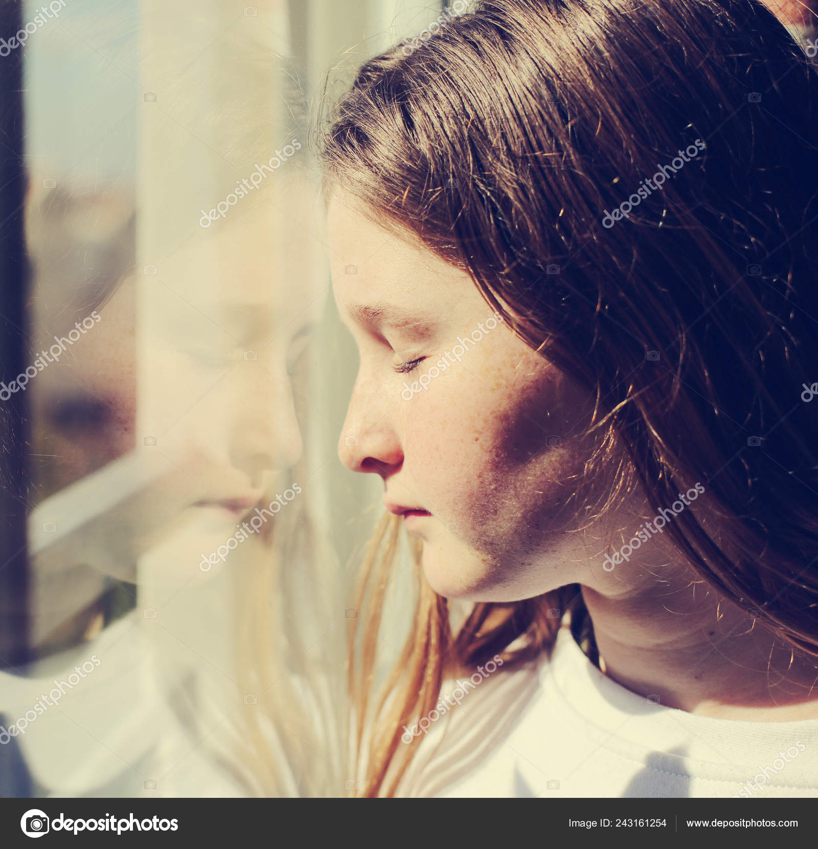 Attractive Sad Teenage Girl Looking Out Window Stock Photo