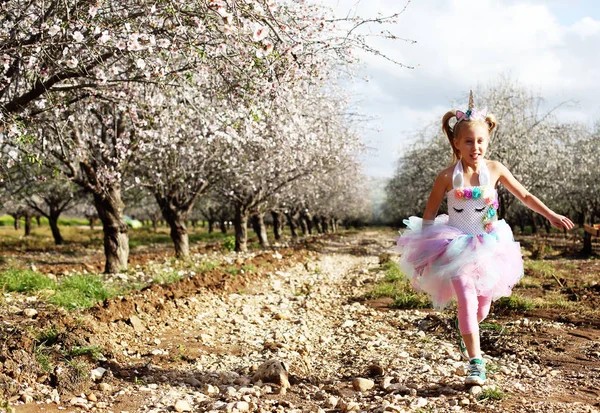 Outdoor portrait of girl in a unicorn costume. Spring is around, — Stock Photo, Image