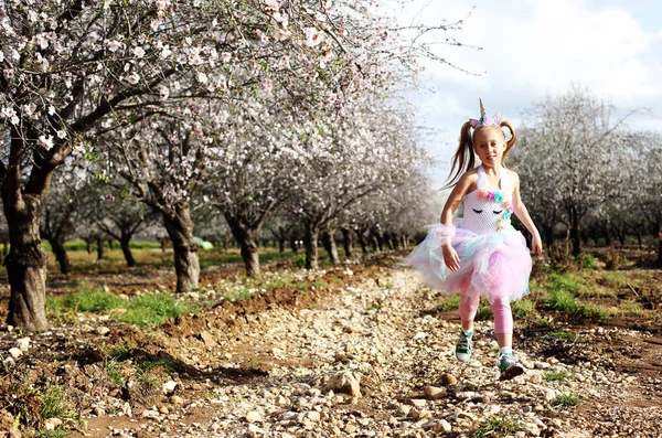 Outdoor portrait of girl in a unicorn costume. Spring is around, — Stock Photo, Image