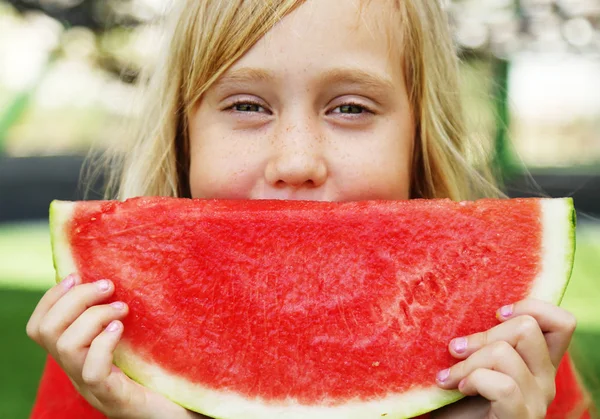 Portrait of cute little 8 years old girl eating watermelon on th — Stock Photo, Image