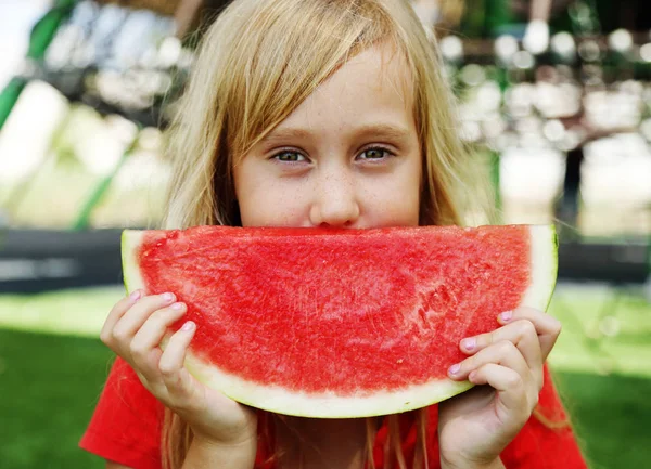 Porträt des niedlichen kleinen 8-jährigen Mädchens, das Wassermelone auf th isst — Stockfoto