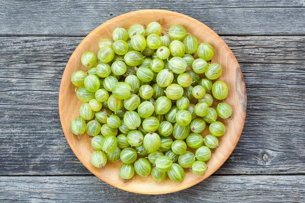 Ripe gooseberries on rustic background — Stock Photo, Image