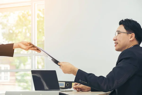 Toplantı ve çalışan ve bir masada office belgelerinde paylaşımı iş adamları