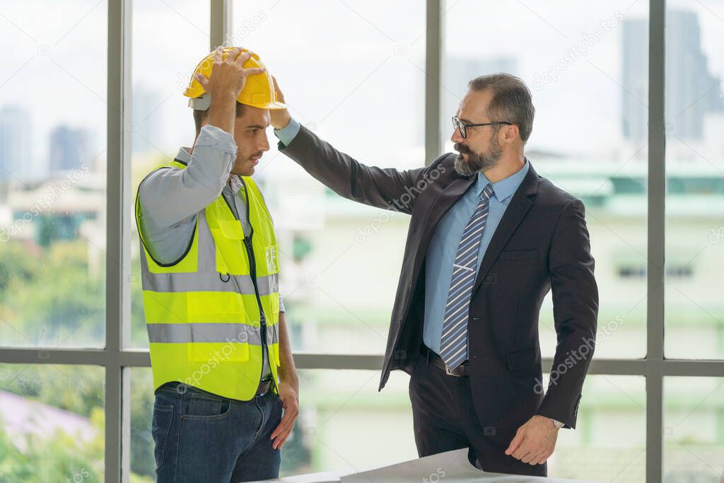 businessman wearing hard safety helmet hat for safety project of workman as engineer or worker