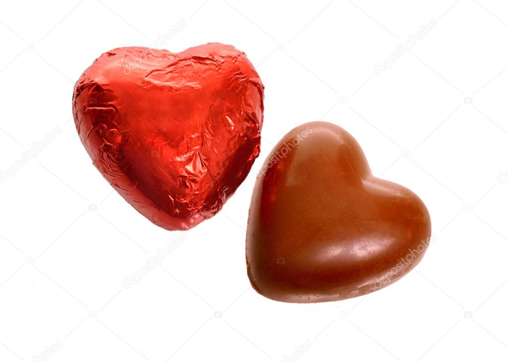 Red Foil wrapped chocolate hearts isolated on white background.
